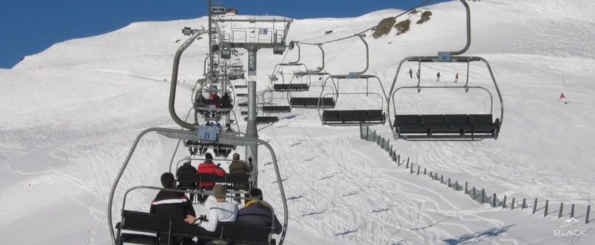 A chairlift ride is used to move to the ski mountain summit.
